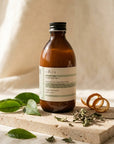 Evera Conditioner No 1 Frequent Use on travertine with green tea leaves and basil sprigs, natural morning light