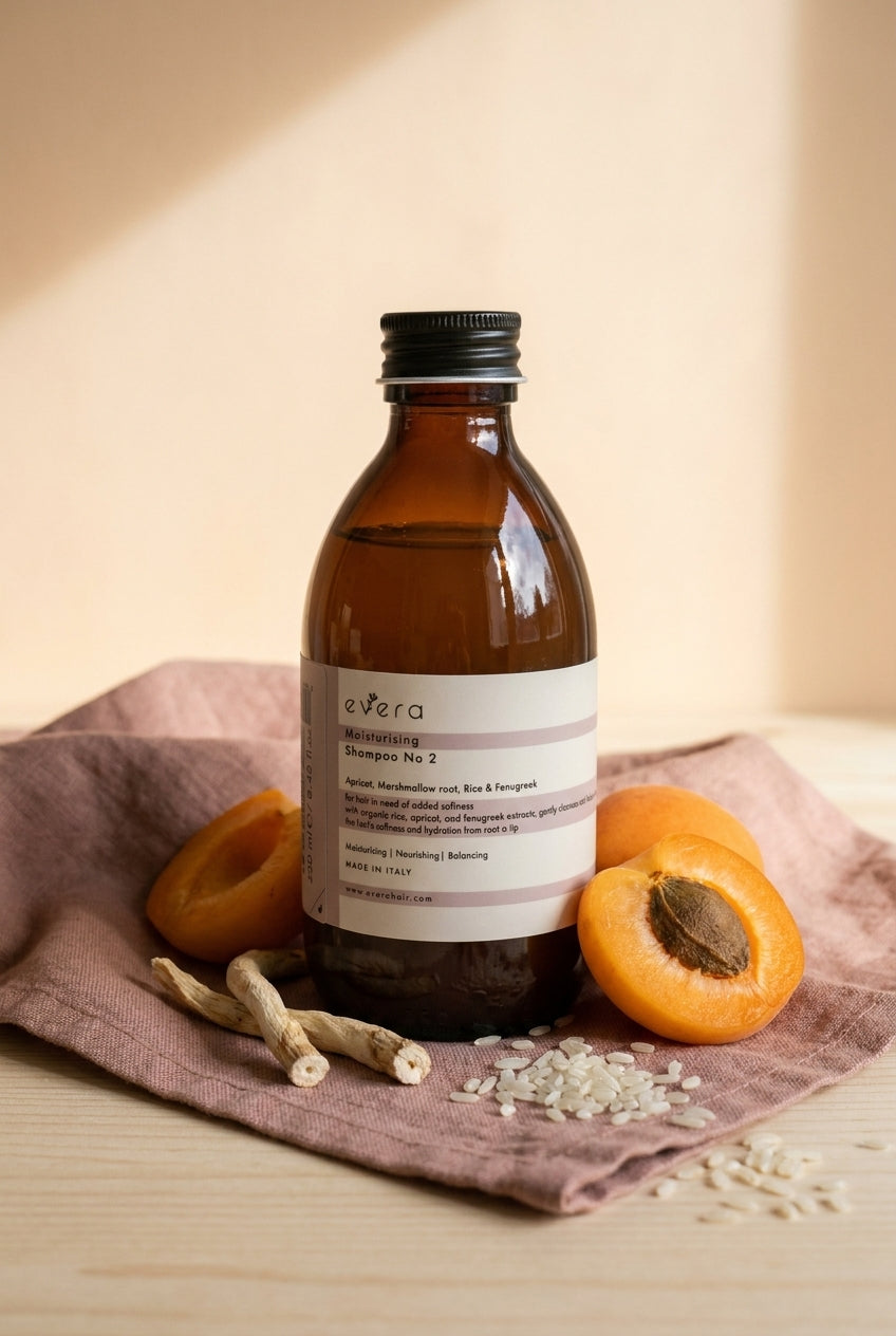 Evera Shampoo No 2 Moisturising with halved apricots on dusty-rose linen, warm ivory-peach backdrop