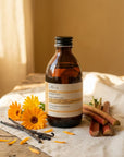 Evera Shampoo No 4 Supherbal Golden Blonde with calendula blossoms and vanilla pod on pine wood, warm ochre backdrop