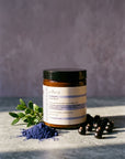 Evera Mask No 5 Supherbal Brunette with indigo powder and boxwood on grey travertine, dusty lavender backdrop
