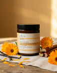 Evera Mask No 4 Supherbal Golden Blonde with calendula and vanilla pod on pine wood, warm ochre backdrop