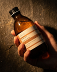 Evera Supherbal Shampoo No.3 held in hand among botanicals